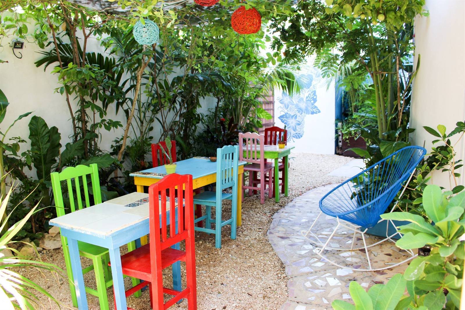 Tiled patio with plants and brightly painted chairs
