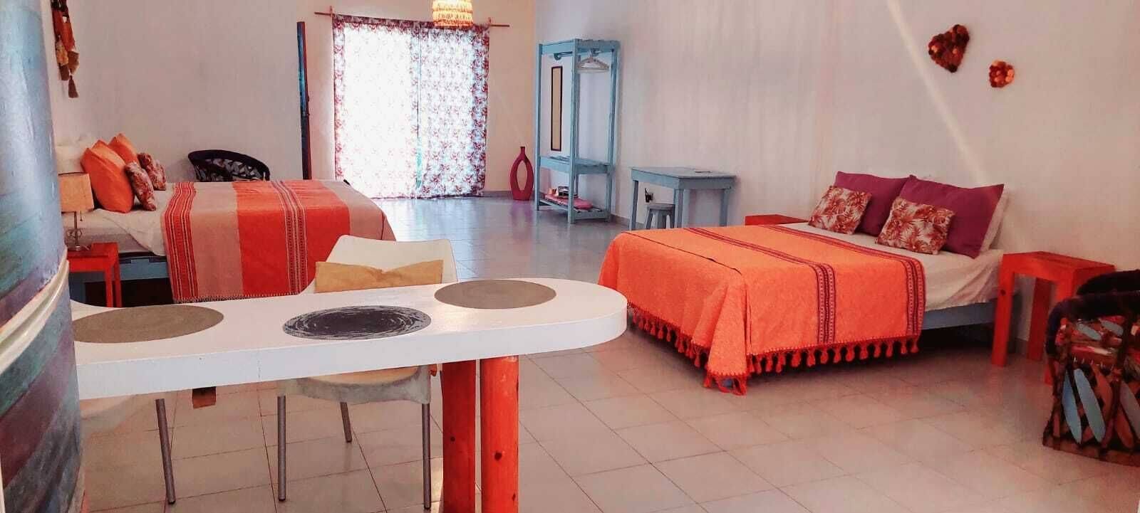 Family studio with a bed, dining table and wardrobe